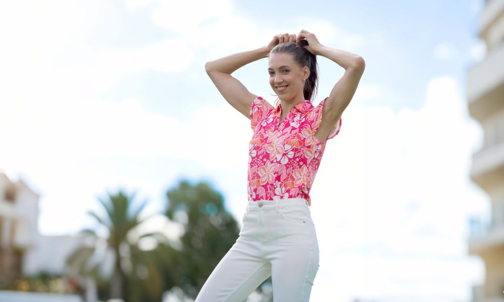 Woman wearing sleeveless pink printed polo shirt